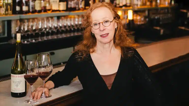Woman sitting at bar with wine glasses