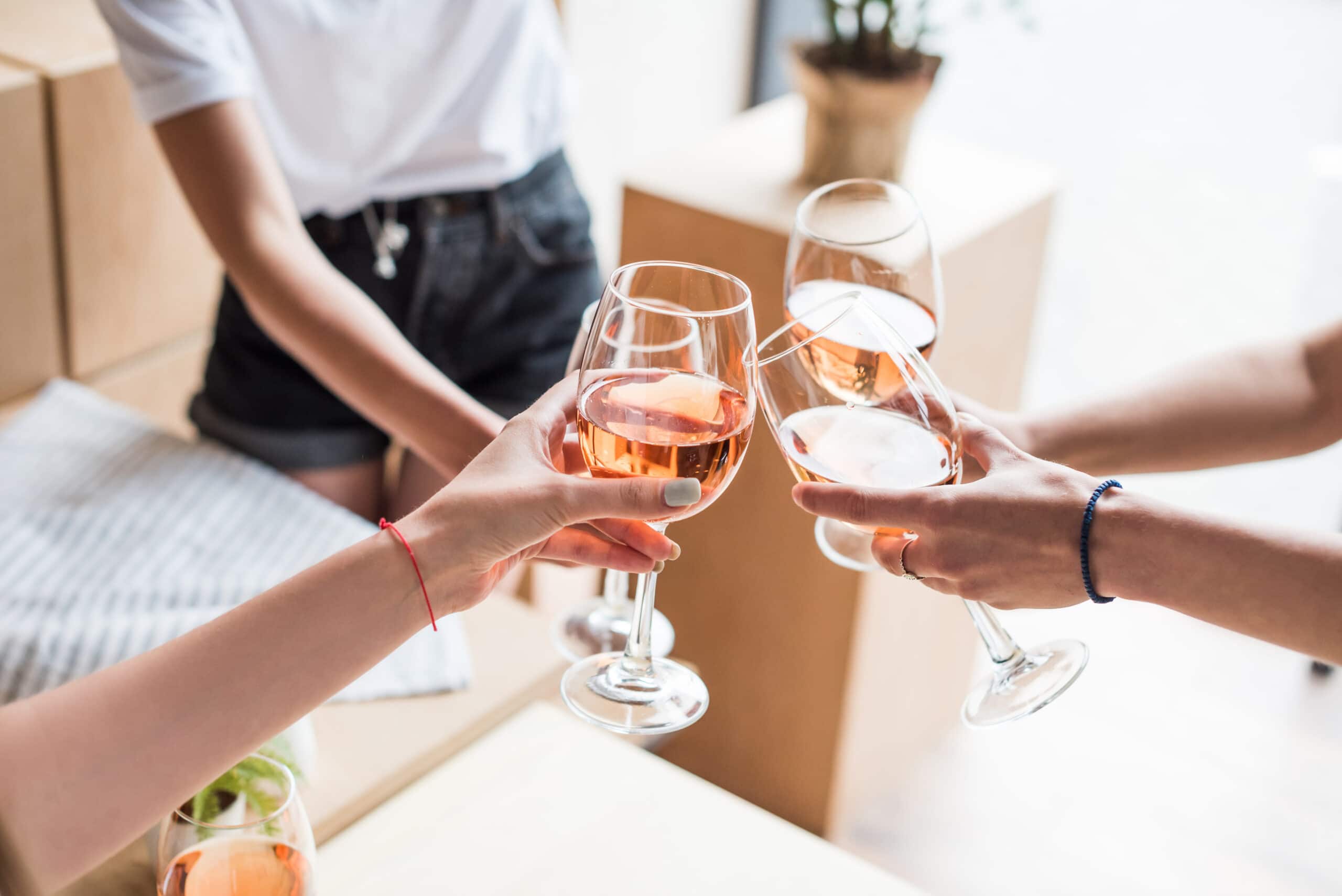 Cropped View Of Women Clinking With Wineglasses With Pink Wine