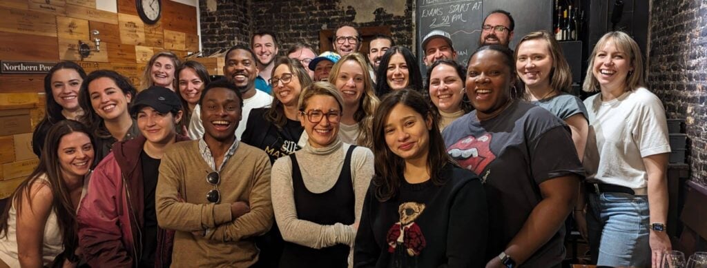 Smiling group of people in a cozy setting.