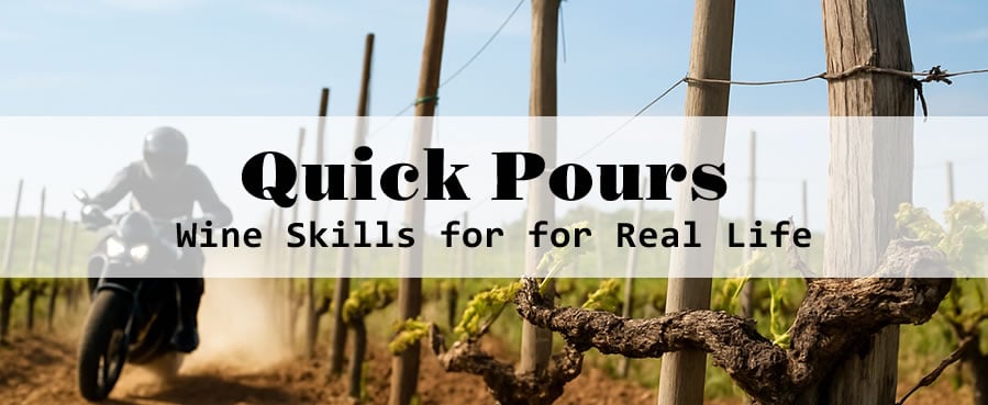 Motorcyclist riding through vineyard, text overlay: Quick Pours.