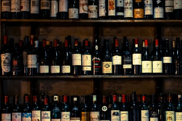 Assorted wine bottles on wooden shelves