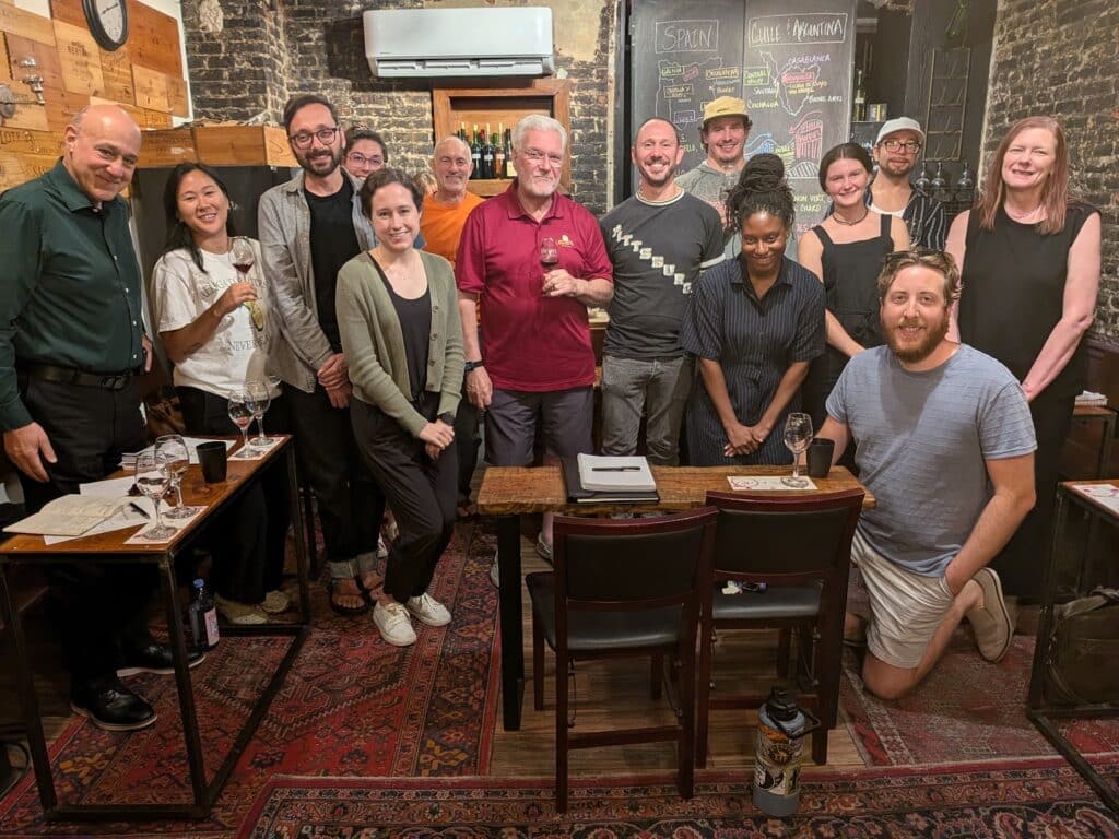 Group posing inside a cozy wine bar